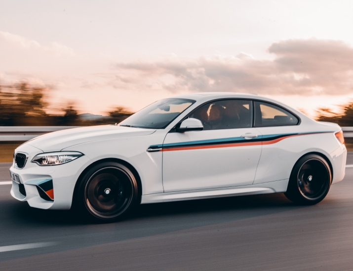 White rental car driving on the road