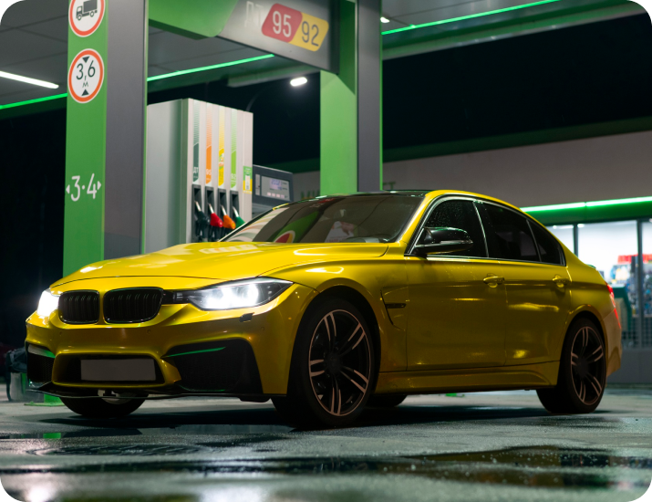 Yellow rental car at a fuel station